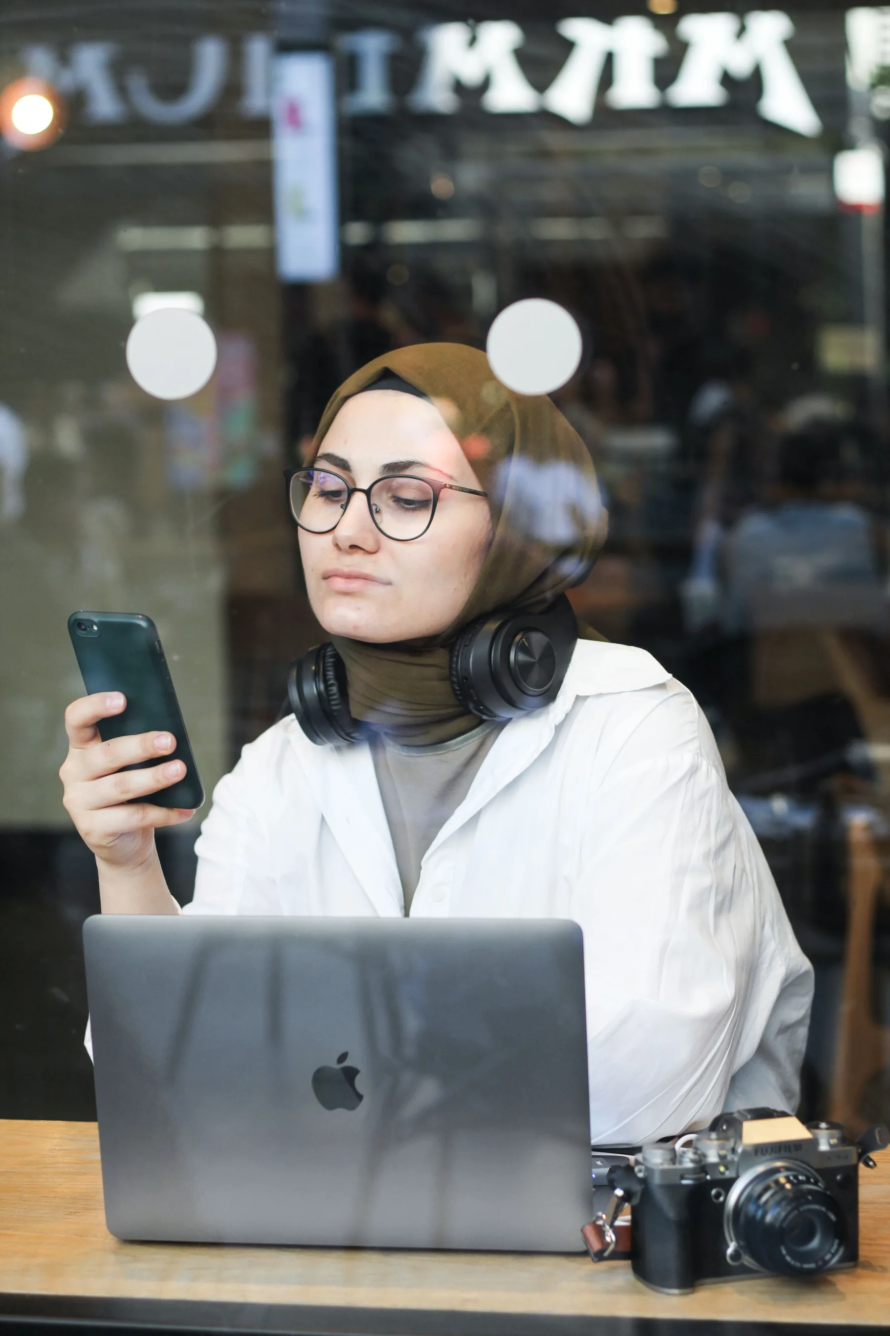 A modern independent business owner working from a cafe